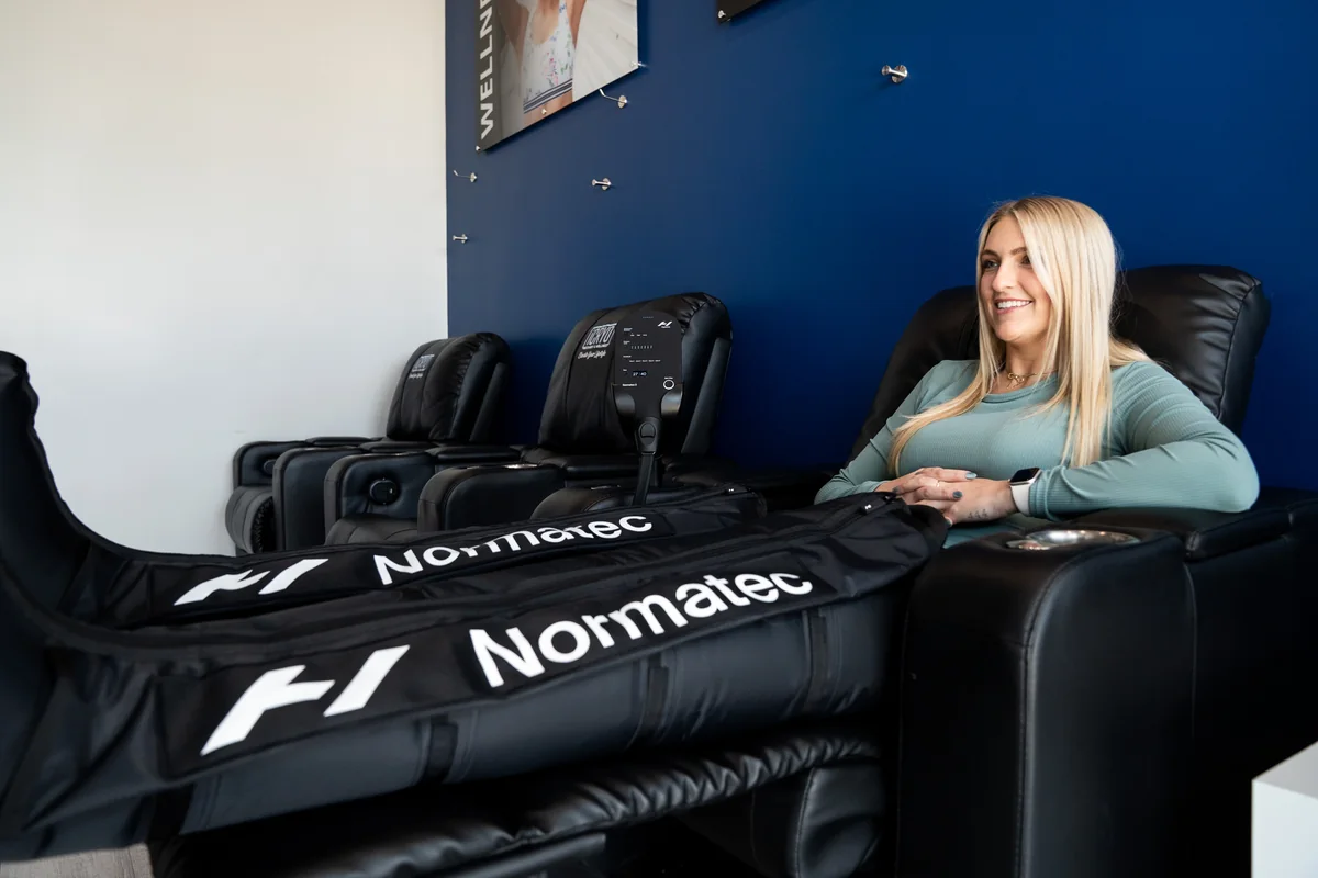 Client reclining with pneumatic compression boots — iCRYO Westminster, CO wellness guide