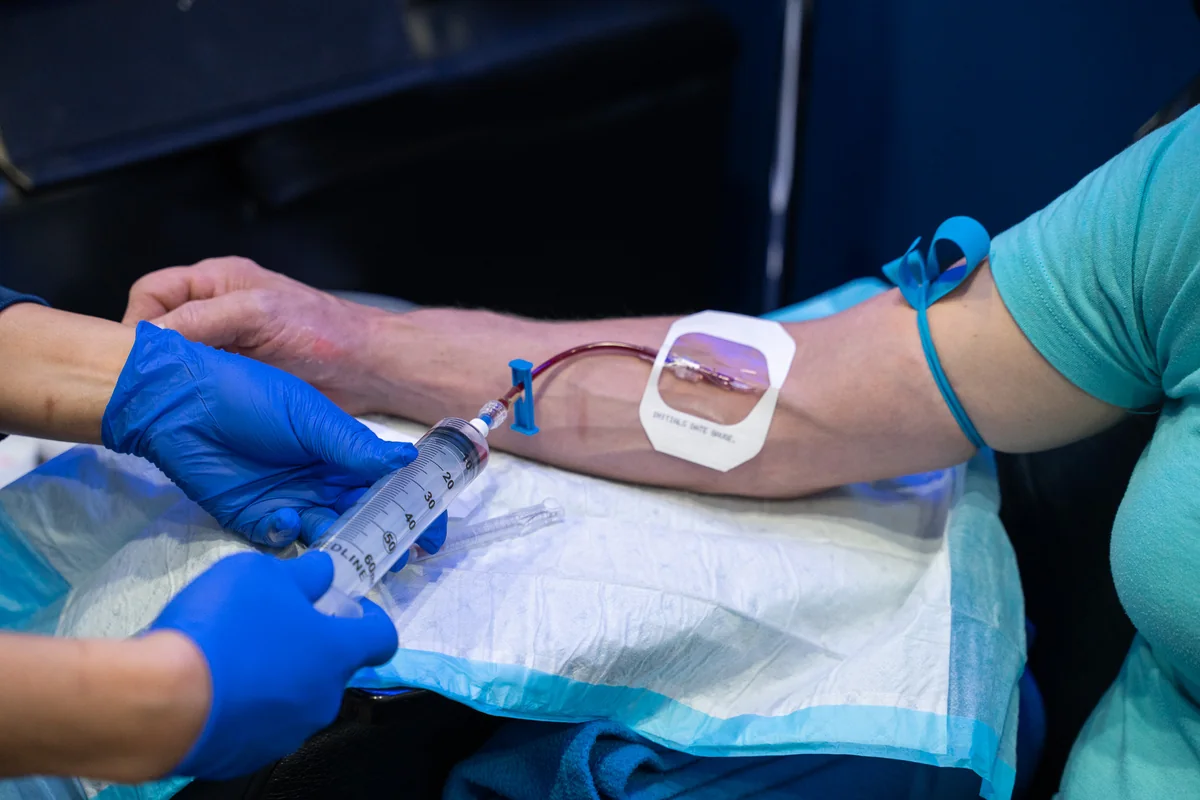 Clinician attending to IV tubing on a client’s arm — iCRYO Westminster, CO wellness guide