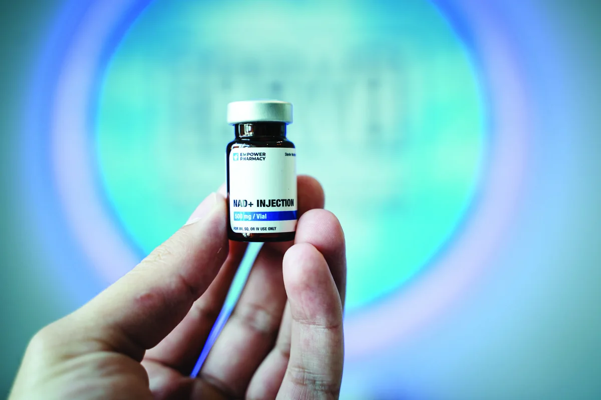 NAD nutrient vial held in front of an iCRYO sign — iCRYO Westminster, CO wellness guide