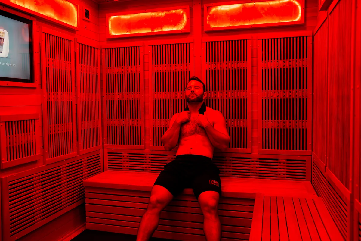 Client relaxing inside a red-lit infrared sauna — iCRYO Westminster, CO wellness guide