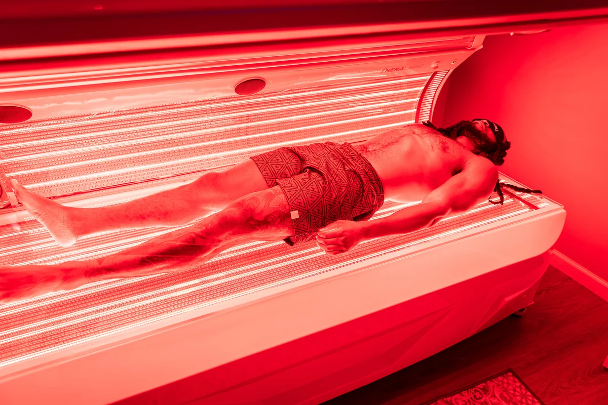 Client resting inside a red light therapy bed — iCRYO Westminster, CO wellness guide