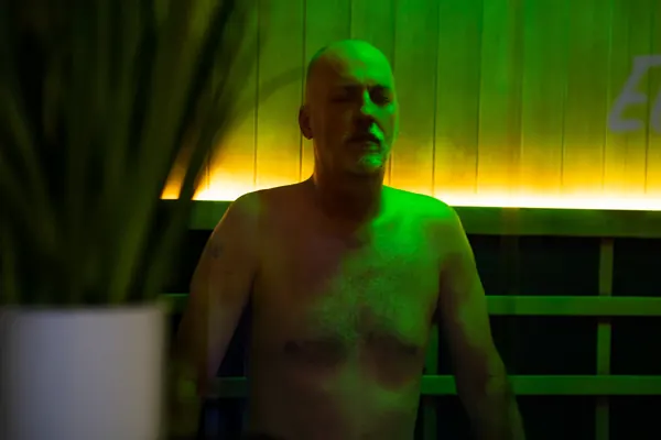Client seated under infrared sauna lighting — iCRYO Westminster, CO wellness guide
