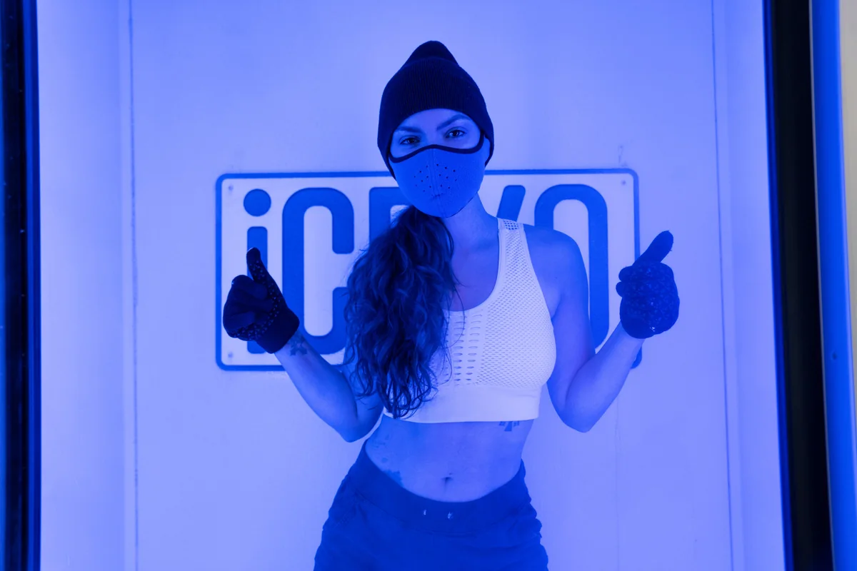 Client inside a blue-lit whole-body cryotherapy chamber — iCRYO Westminster, CO wellness guide