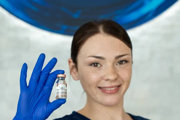Clinician displaying a nutrient vial — iCRYO Westminster, CO wellness guide