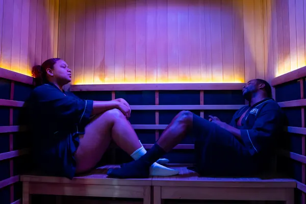 Two clients seated on sauna benches — iCRYO Westminster, CO wellness guide