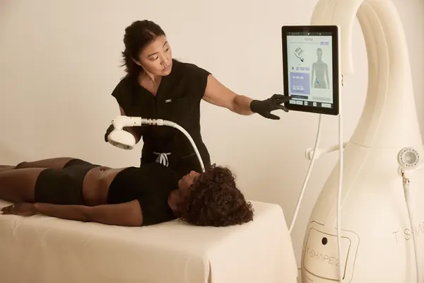 Clinician operating a T-Shape 2 device during a body treatment — iCRYO Westminster, CO wellness guide