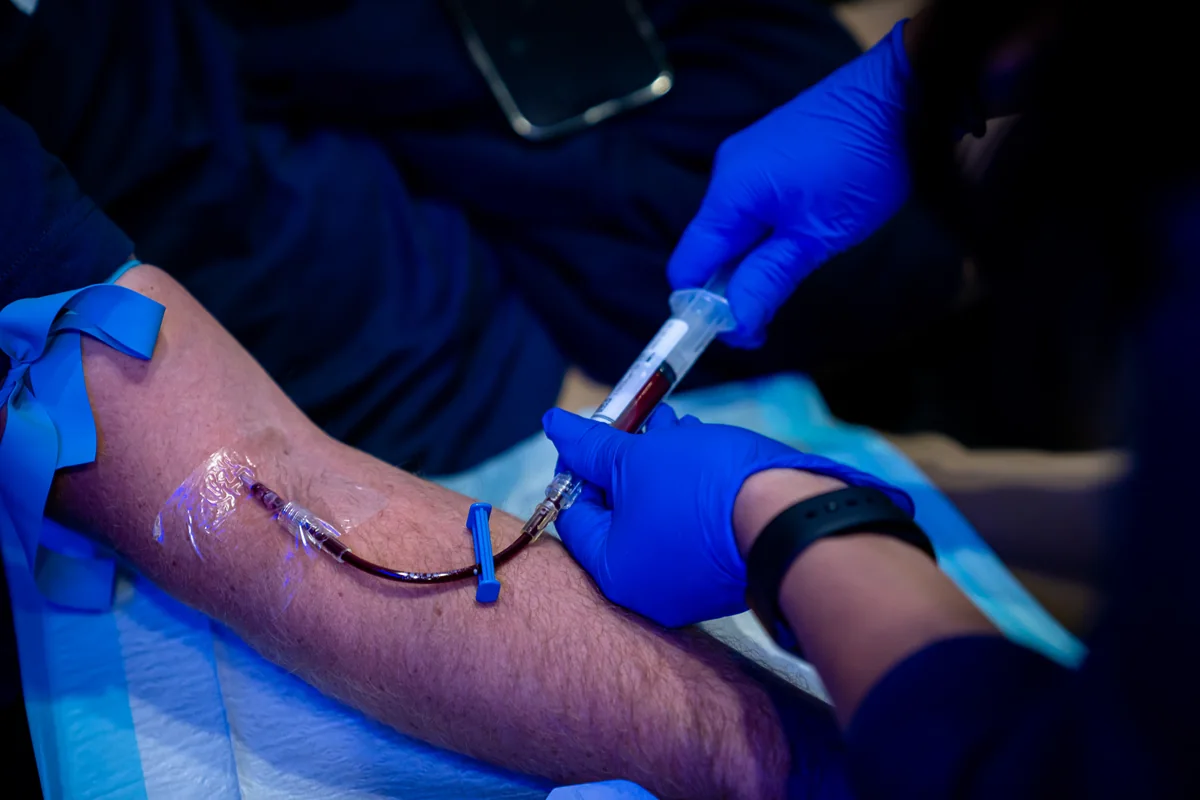 Clinician wearing gloves while managing an IV line — iCRYO Westminster, CO wellness guide