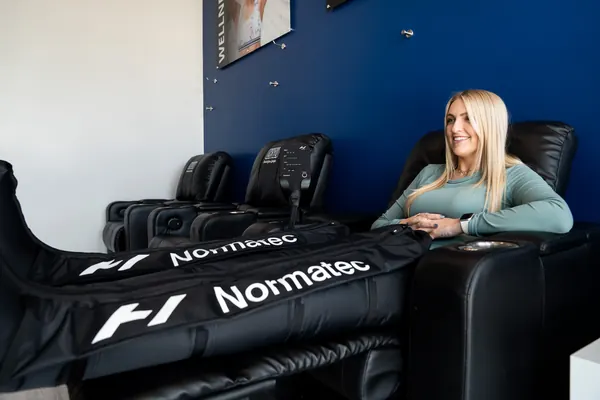 Client reclining with pneumatic compression boots — iCRYO Westminster, CO wellness guide