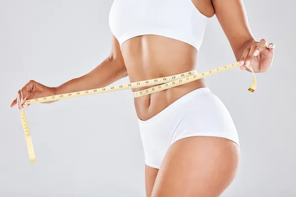 Measuring tape around the waist — iCRYO Westminster, CO wellness guide