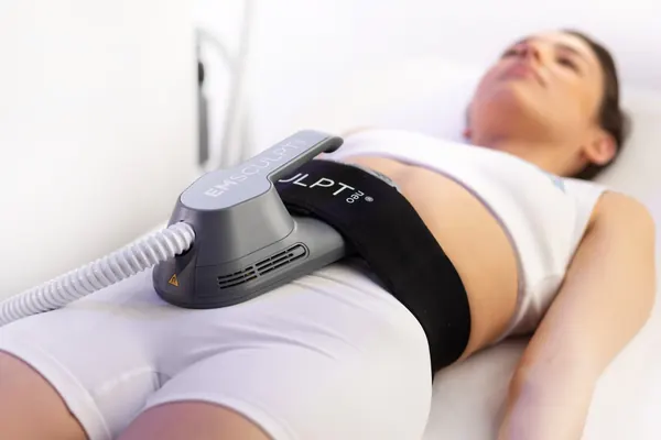 Client reclining with an EMSCULPT NEO abdominal applicator — iCRYO Westminster, CO wellness guide