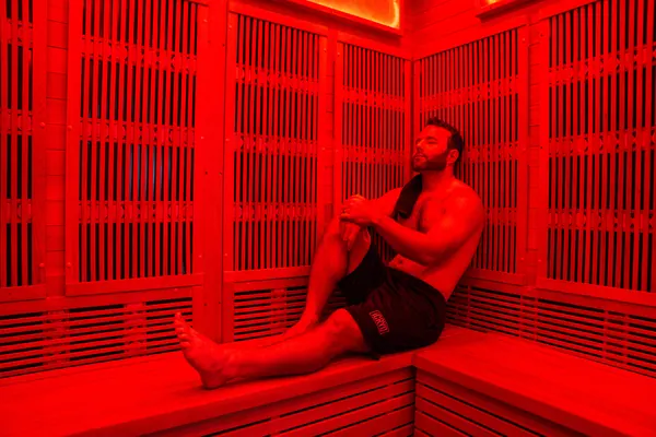 Client seated inside an infrared sauna — iCRYO Westminster, CO wellness guide