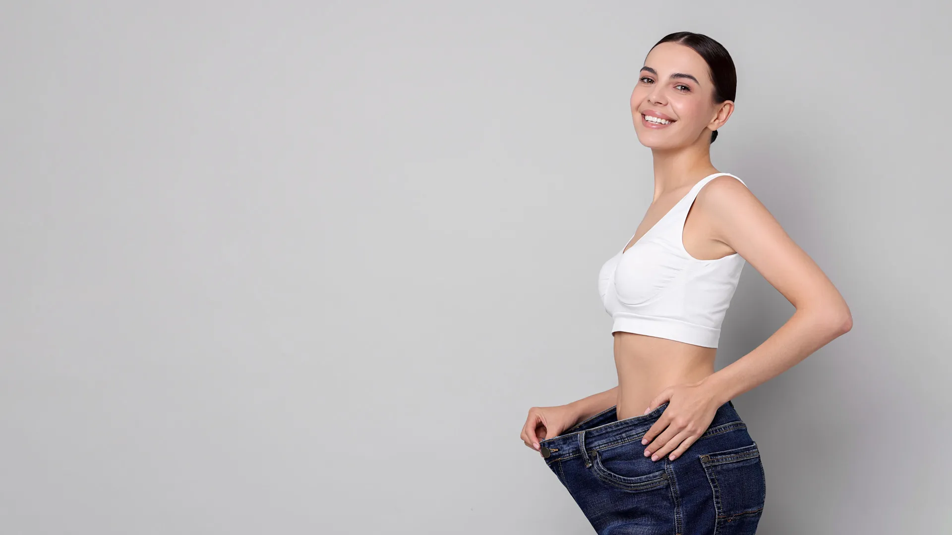 Woman celebrating weight loss results at iCRYO Westminster Medical Weight Loss program